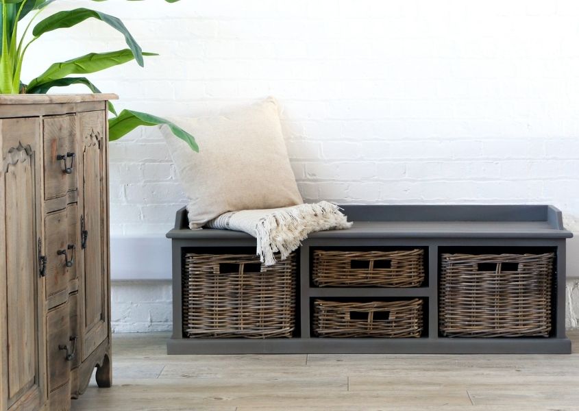 grey reclaimed wood storage bench with rattan baskets