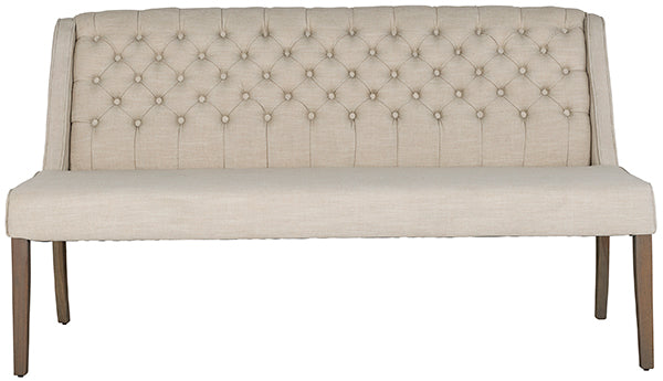 A cream button back dining bench on rustic wooden legs
