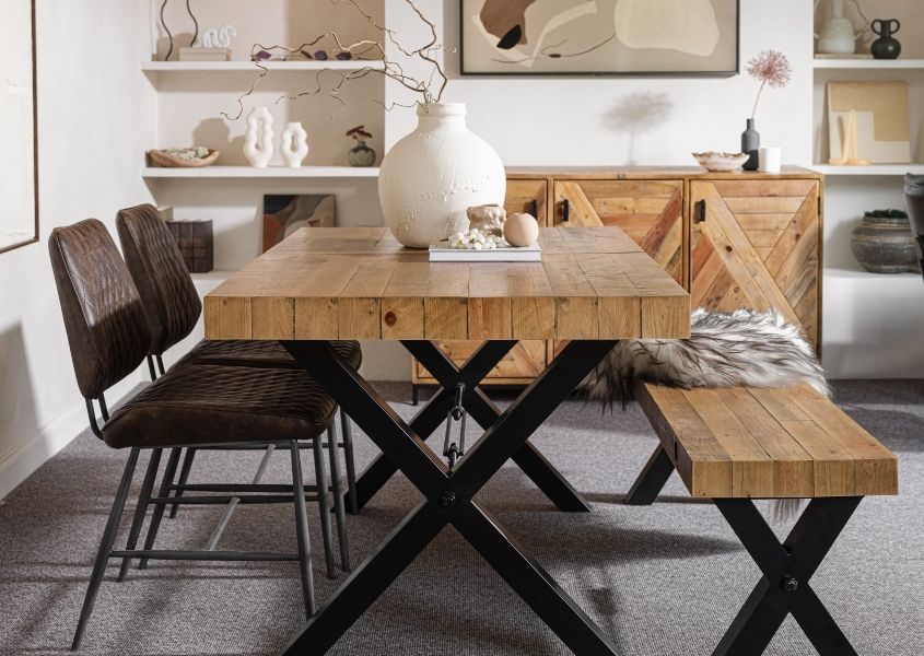 reclaimed wood dining table with black steel cross-shaped legs