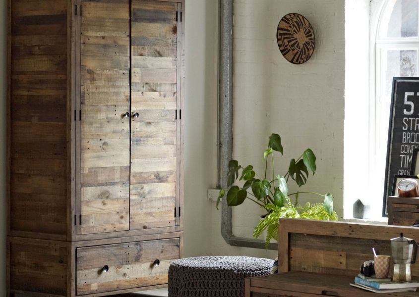 reclaimed wooden wardrobe in bedroom with rustic furniture