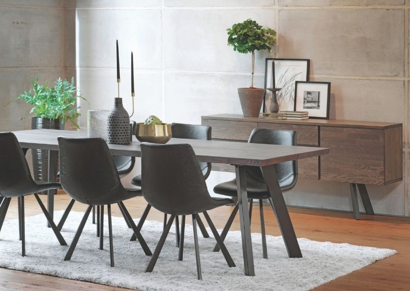 Dining room with modern oak industrial dining table with grey metal legs and dark grey dining chairs