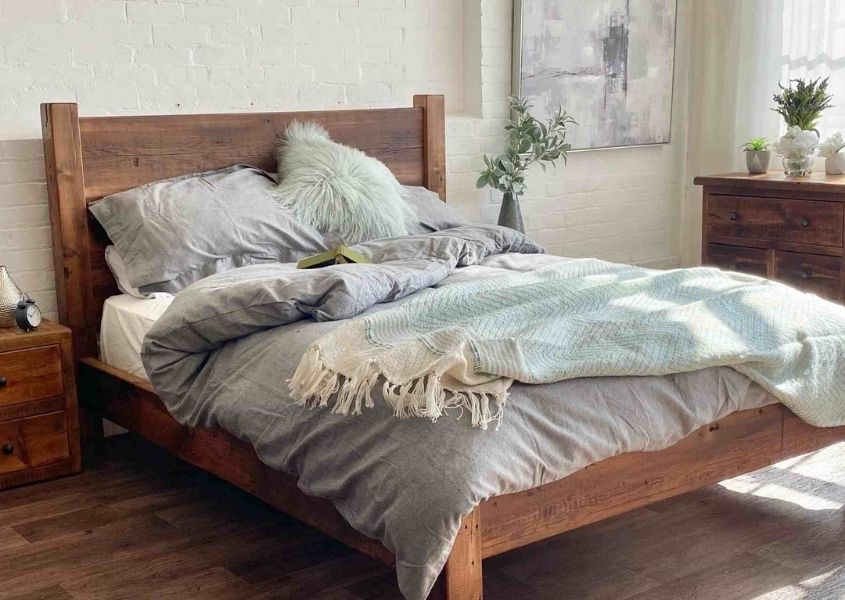 reclaimed wood bed with grey and pale green covers