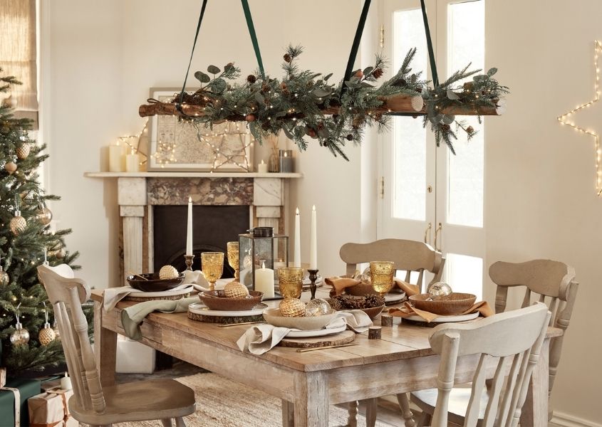 rustic dining table with natural hanging Christmas decoration above