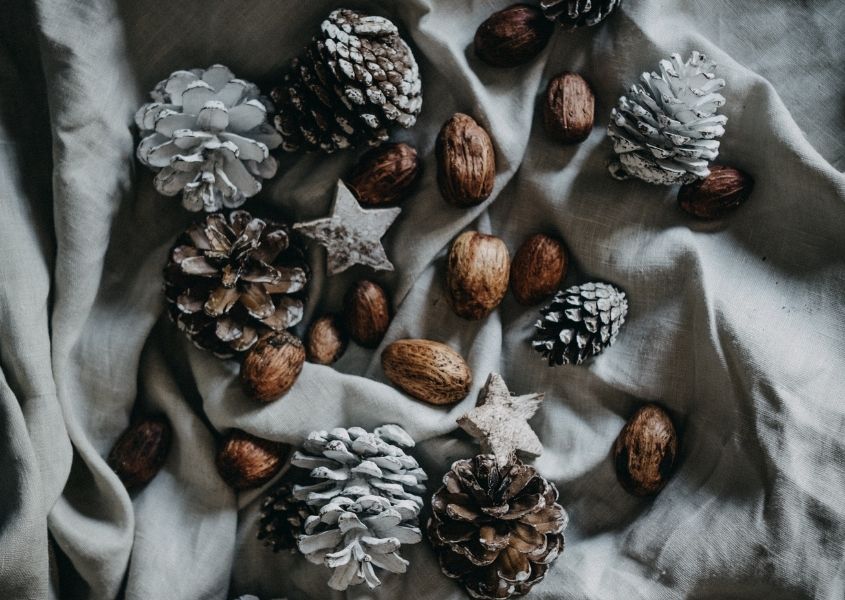 Christmas rustic pine cones and acorns on grey table cloth
