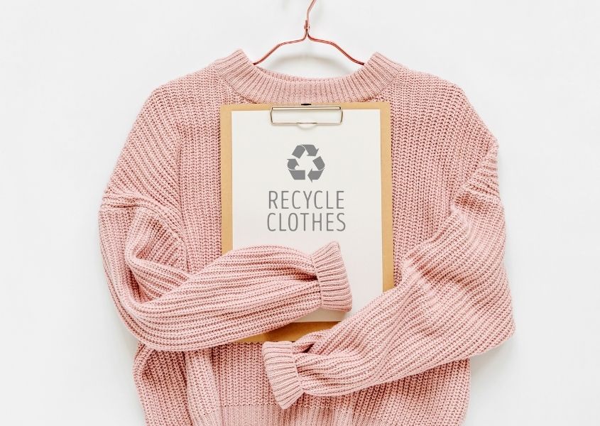 pink wood jumper with recycle card for how to declutter your wardrobe responsibly blog