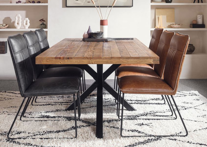 industrial style dining table with brown and grey faux leather dining chairs