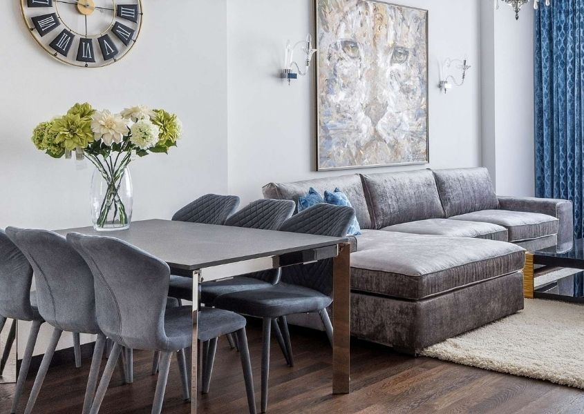 Grey fabric sofa with metal dining table and grey dining chairs