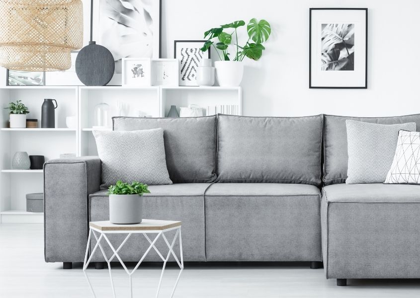Grey L shaped sofa in white modern living room