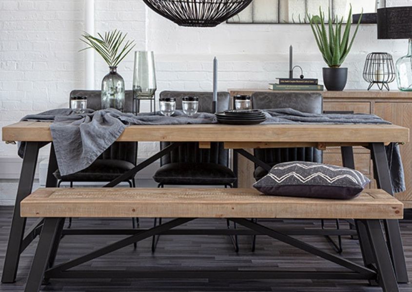 Industrial dining table with dark grey steel legs and matching wooden bench