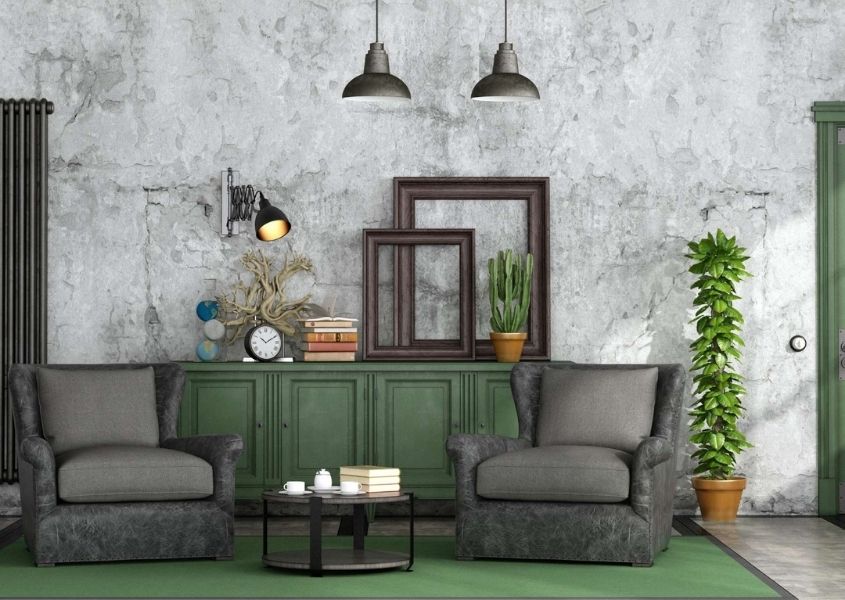 Grey industrial living room with two grey armchairs, concrete wall and industrial hanging ceiling lights