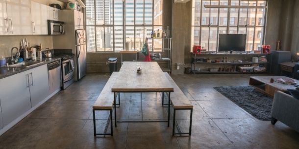 Loft apartment with industrial dining table and large metal paned windows