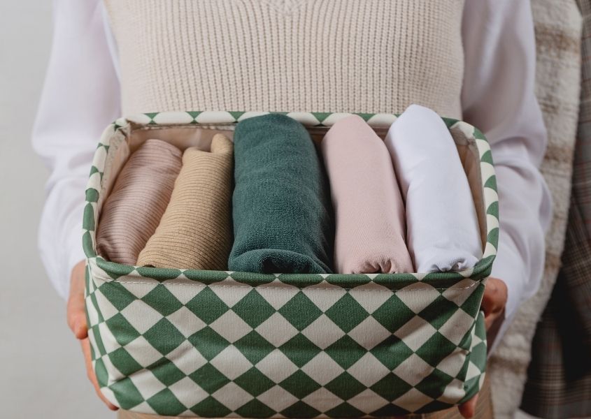 clothes folded in checked basket for 5 ways to give your home a new year's detox blog