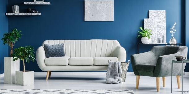 white sofa against blue wall for 5 ways to give your home a new year's detox blog
