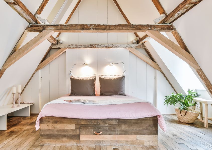 white bedroom with rustic solid wood bed and pink covers