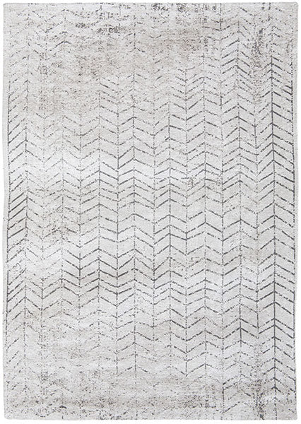 A light grey rug in a soft geometric pattern