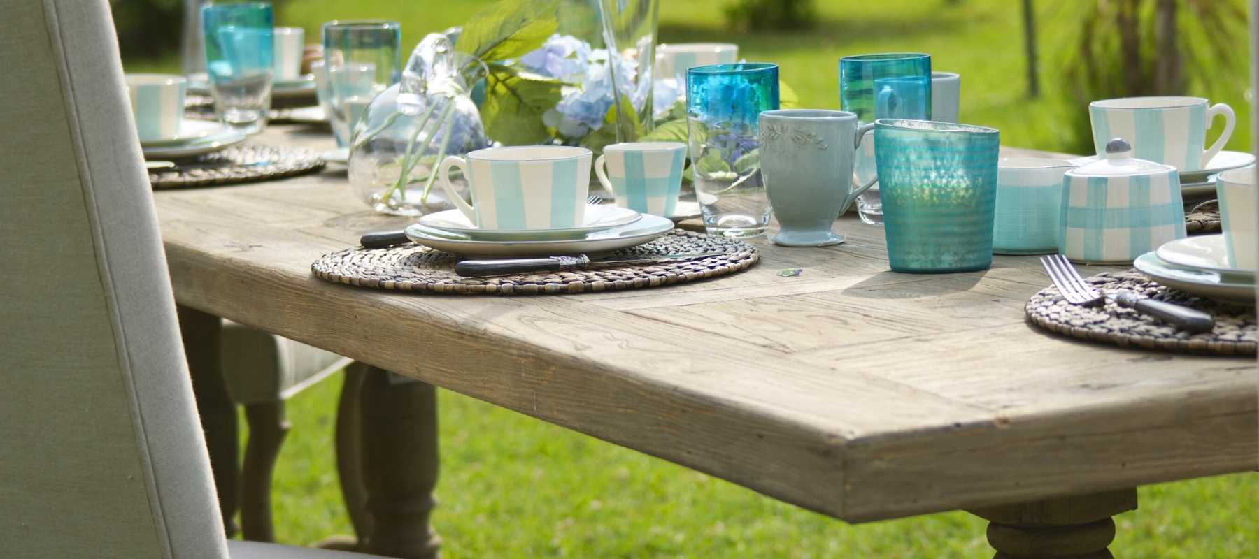 Reclaimed wood dining table with blue glasses
