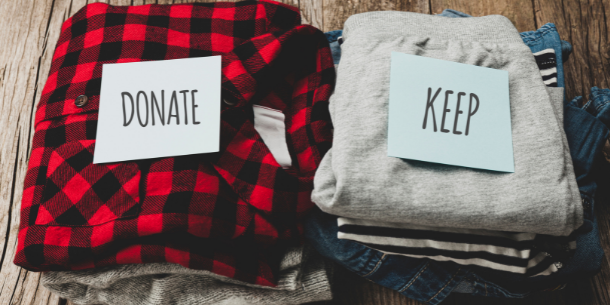 Pile of clothes to donate or keep for how to declutter your wardrobe responsibly blog