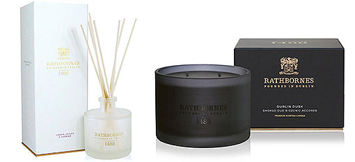Scent diffuser in white glass pot and black scented candle