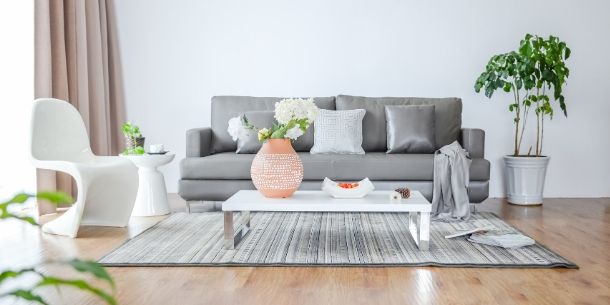 Grey sofa with grey floor rug and coffee table