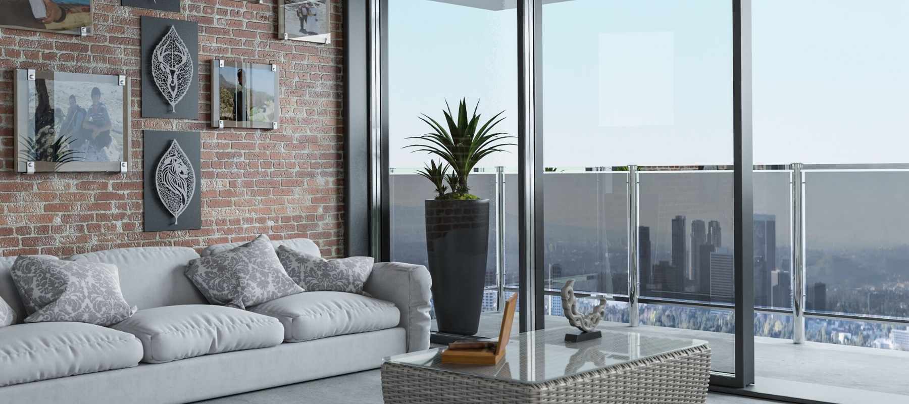 Grey sofa with large windows to balcony