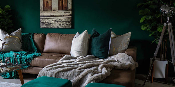 Brown Leather Sofa in Living Room with Dark Green Walls