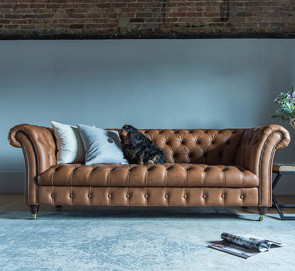 Tan Leather Chesterfield Sofa with Blue Rug
