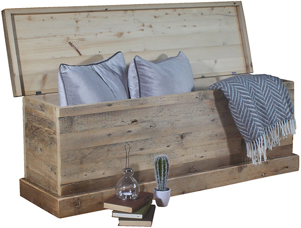 Grey finished reclaimed wood blanket box with pillows and a throw
