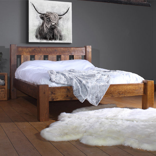 English Beam Reclaimed Wood Bed in Bedroom with sheepskin rug