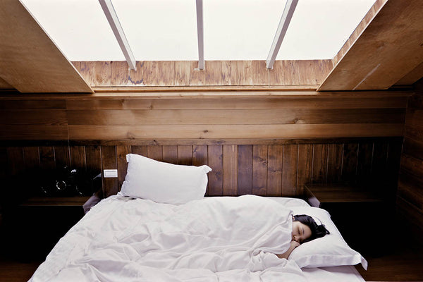 Women sleeping in reclaimed wood bed
