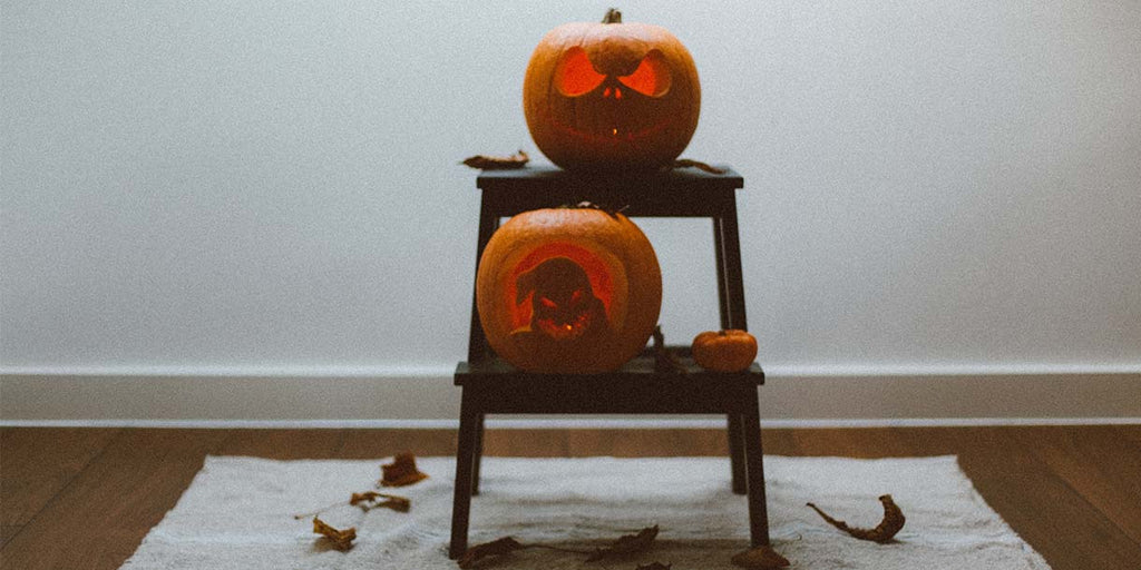 Two pumpkins on wooden chair