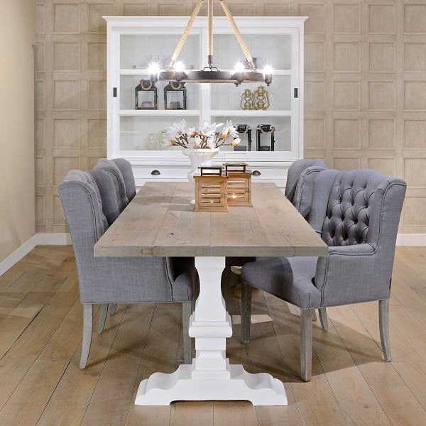 reclaimed wood dining table with white legs in farmhouse dining room with white kitchen dresser
