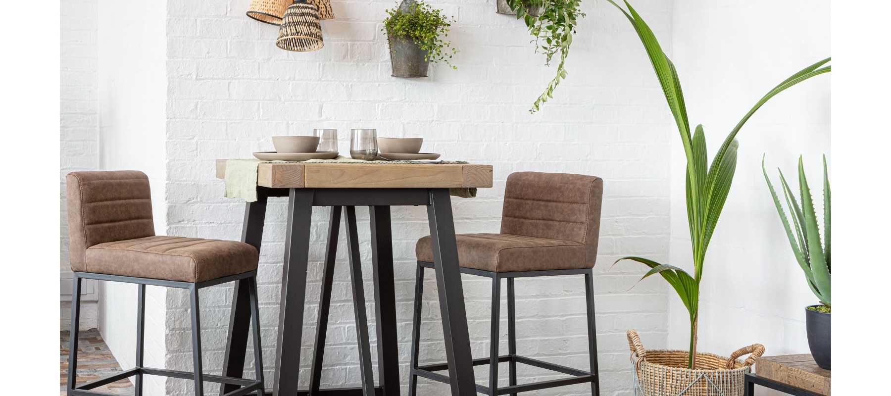 Wooden bar table with black steel legs and bar stools
