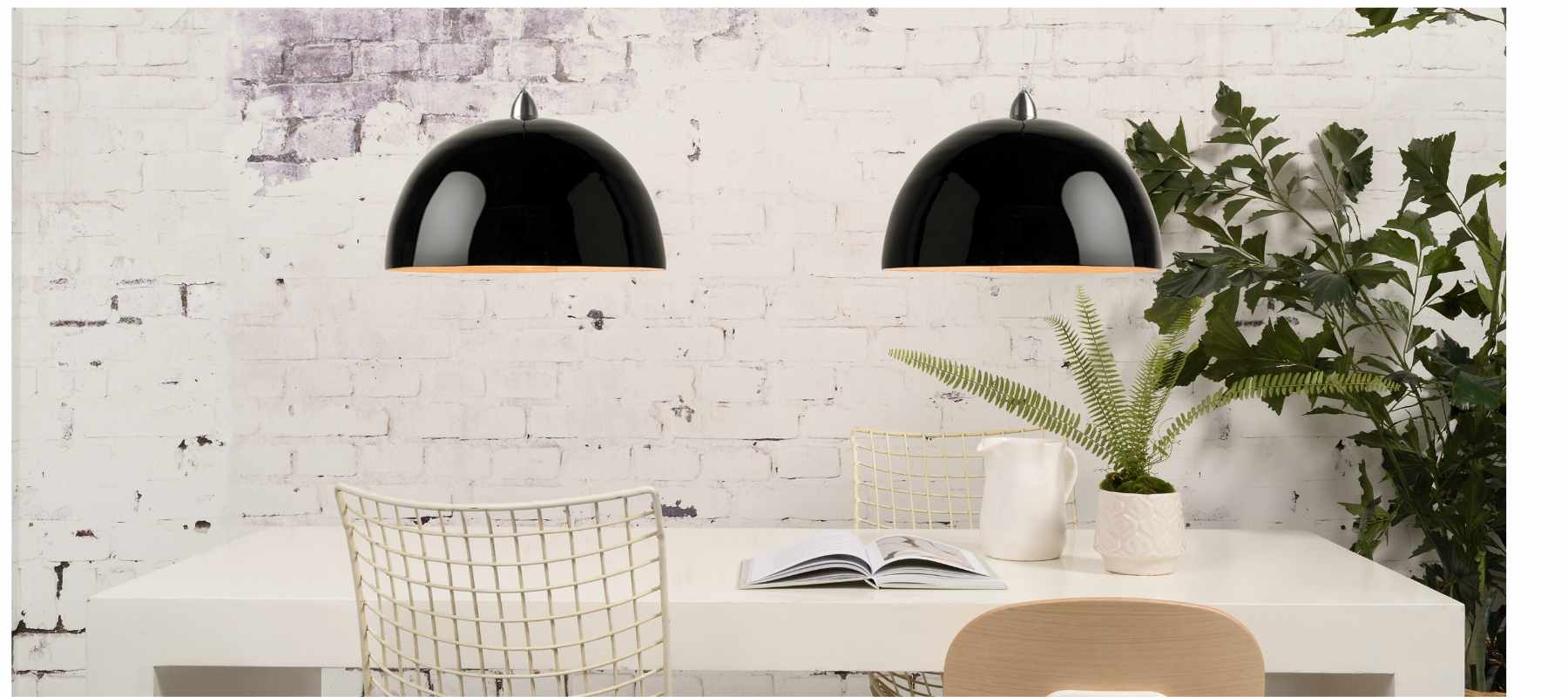 Black double pendant lighting with white exposed brick wall