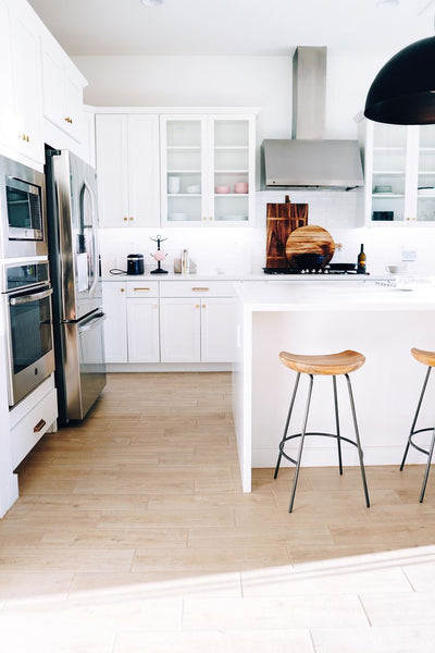 White kitchen with wooden stools