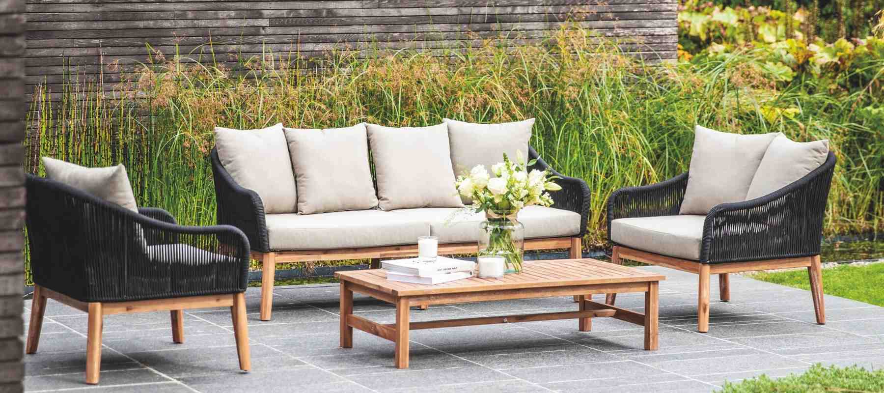 Wood framed garden sofa set with white cushions and coffee table