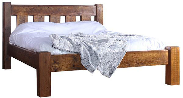 A reclaimed wood bed with white bedding