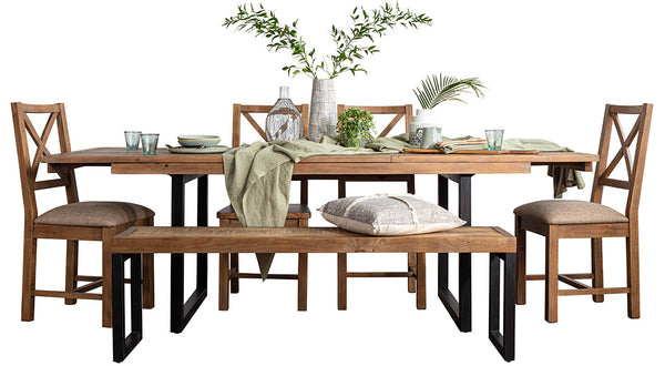 An industrial style reclaimed dining set with matching chairs and dining bench