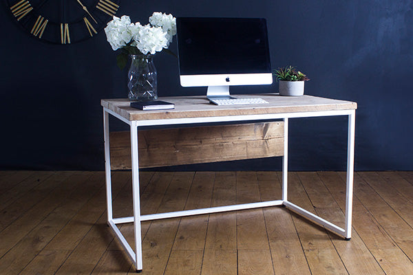 Reclaimed wood desk with white steel frame and decorative items on top