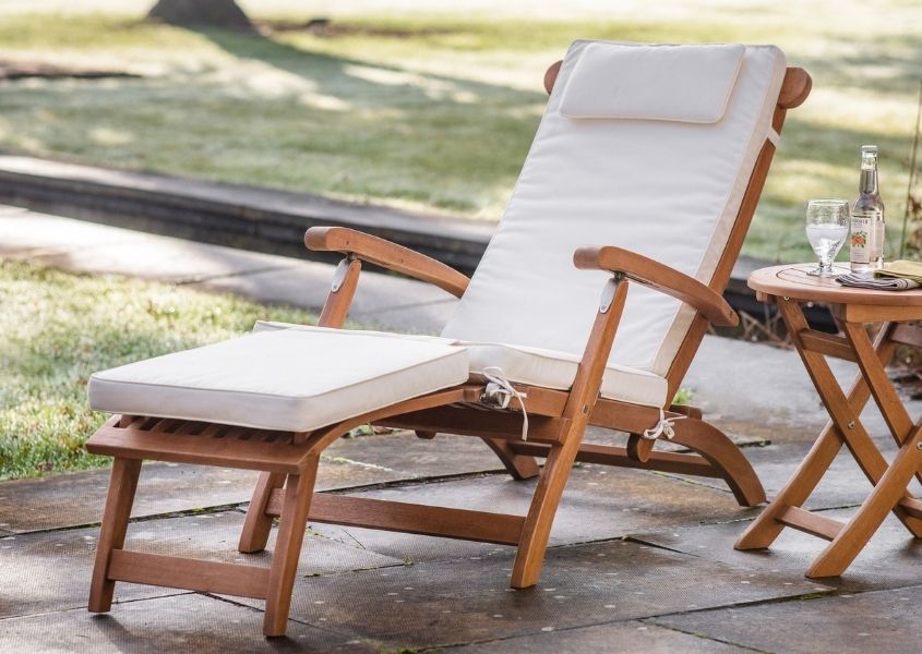 wooden lounge chair with white cushion