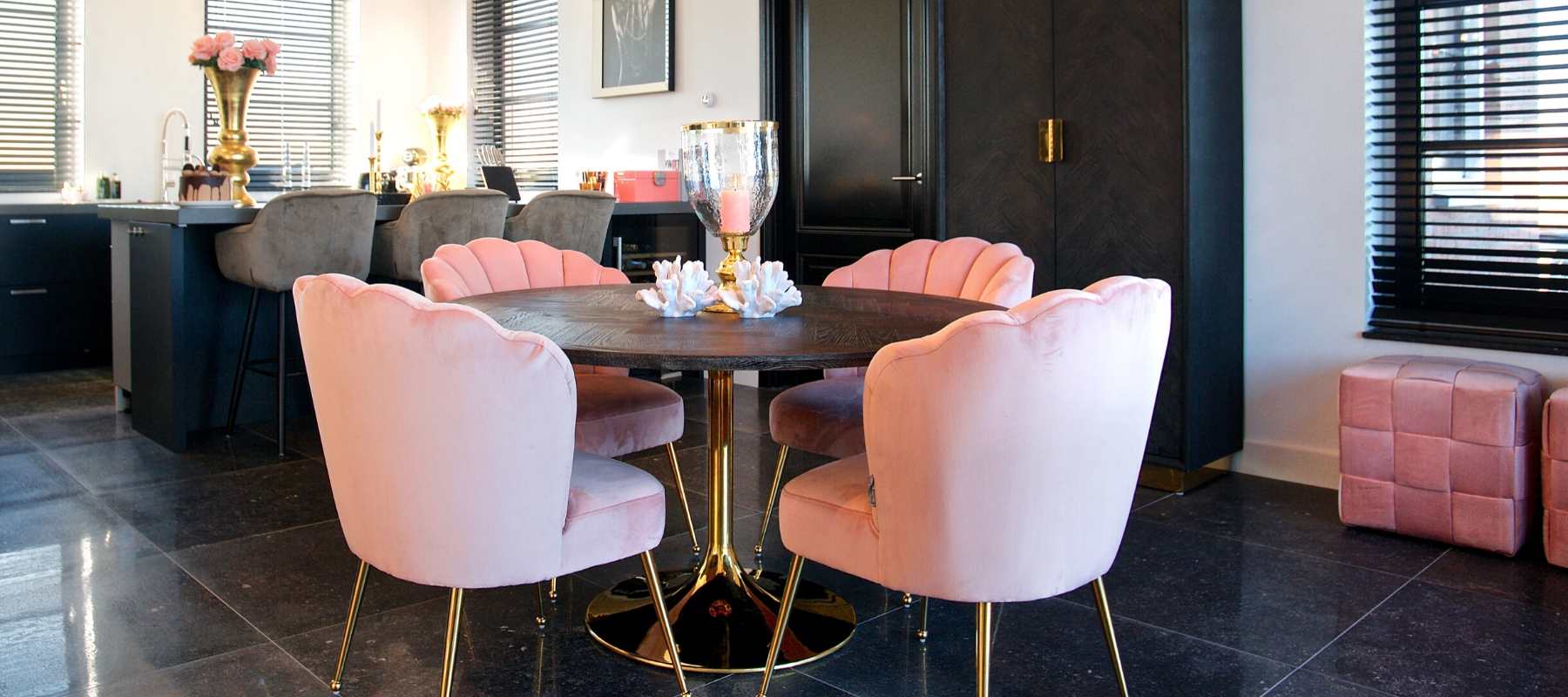 Dark wood dining table with pastel pink upholstered dining chairs