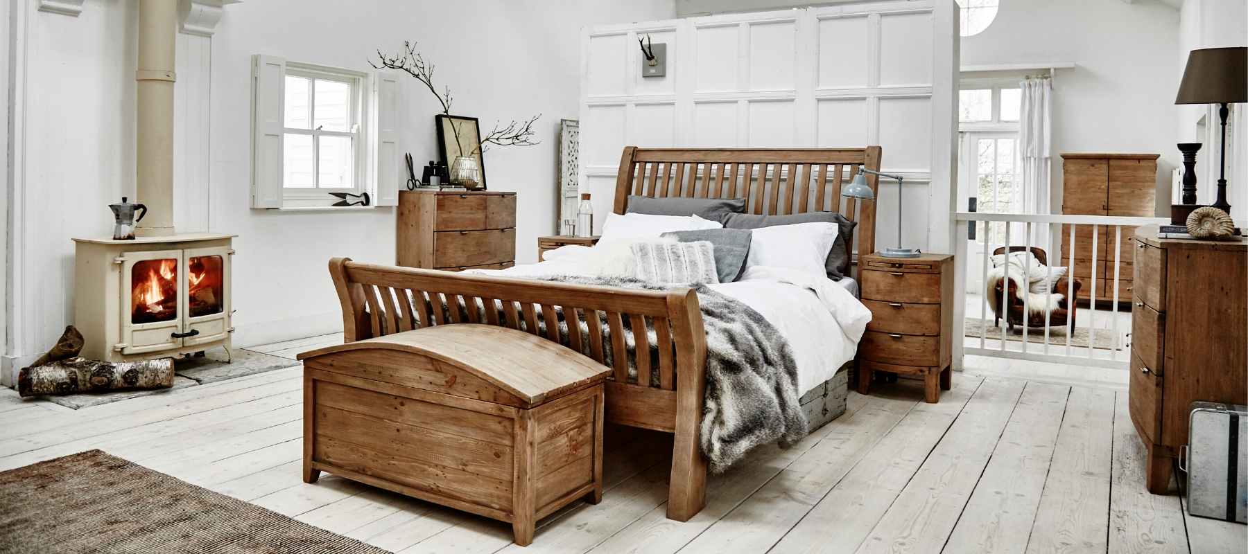 Rustic styled white bedroom including reclaimed wood bed, blanket box and chest of drawers