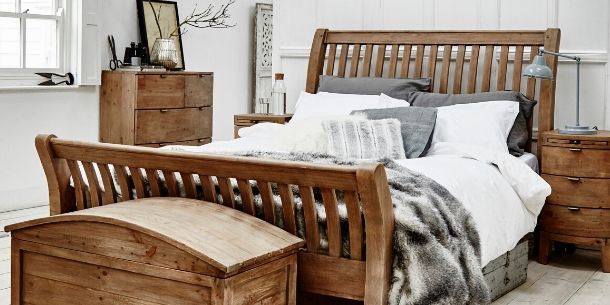 Rustic reclaimed wood bed frame with wooden blanket box and bedside table