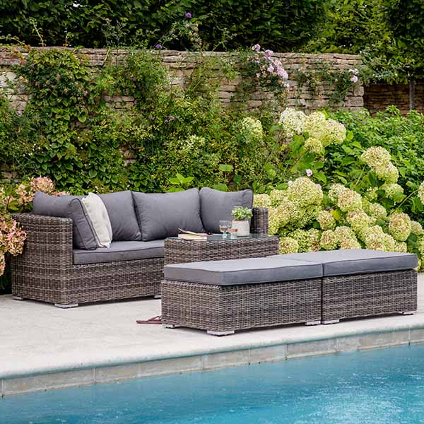 Selborne Double Rattan Lounger Set with grey Cushions in Garden