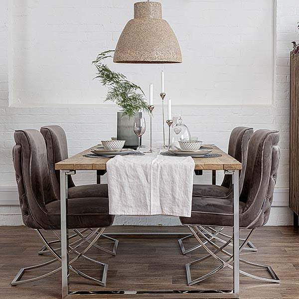 Rustic and glamorous dining table with velvet taupe chairs, a cream pendant and white table linen