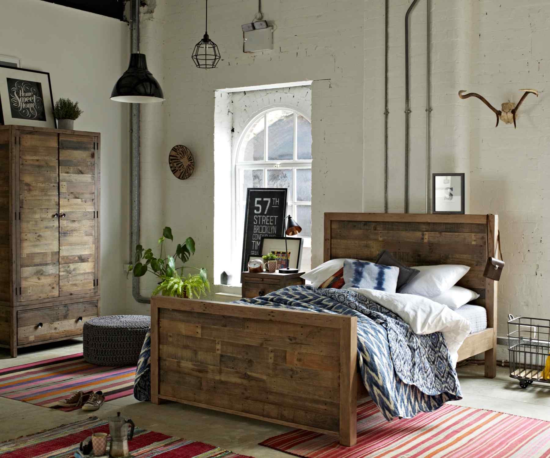 Reclaimed wood bed in bedroom with matching wardrobe