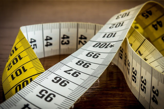 Tape Measure on Wooden Desk