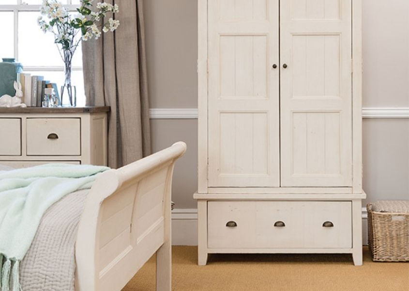 painted wardrobe with drawer and white solid wooden bed