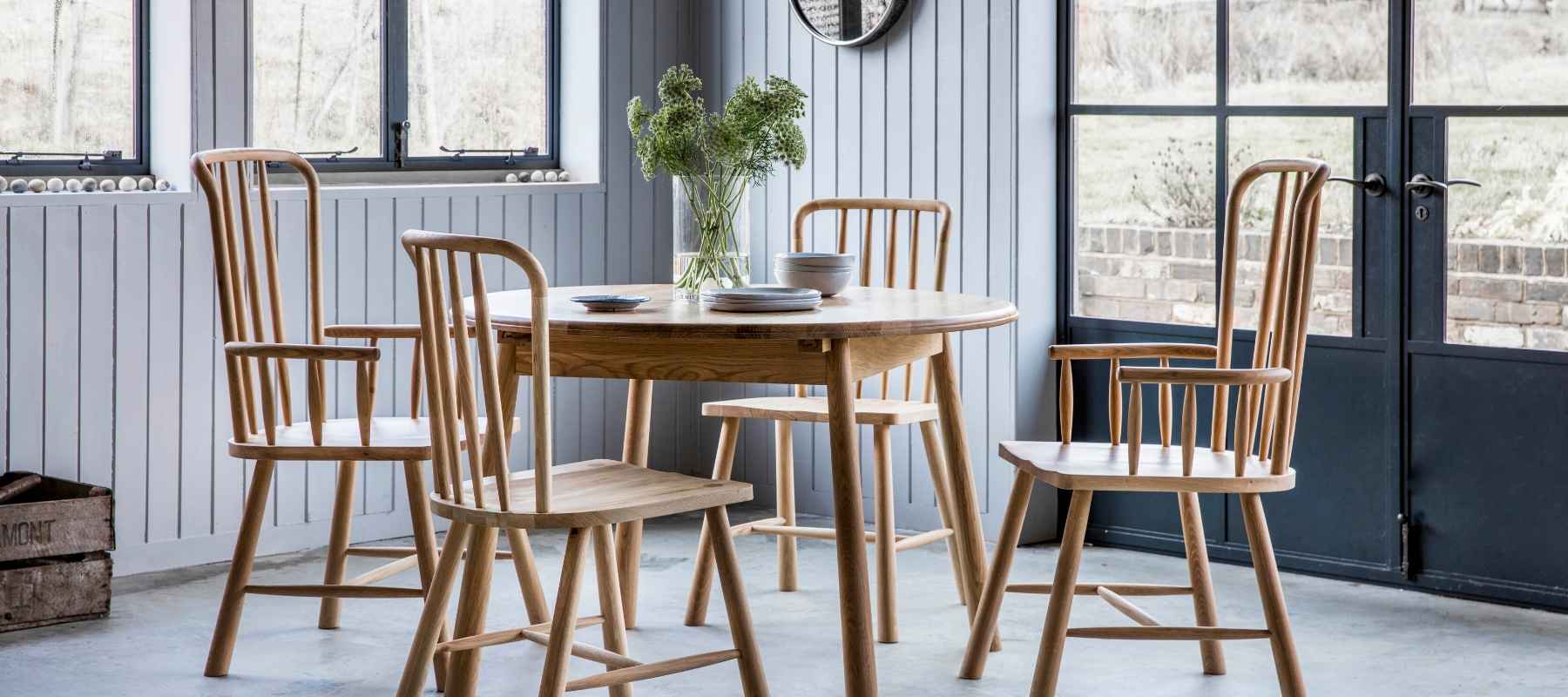 Round wooden dining table with wooden chairs