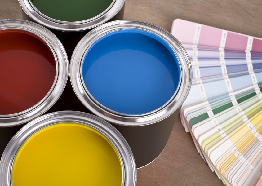 tins of paint with paint colour chart