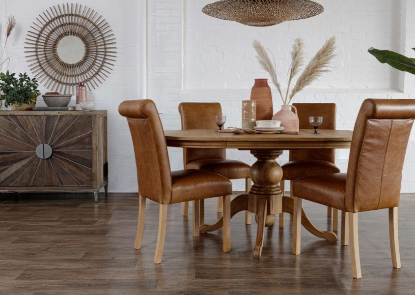 round oak dining table with brown leather dining chairs